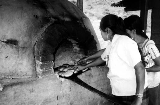 Women baking bread in over in Chiapas Mexico